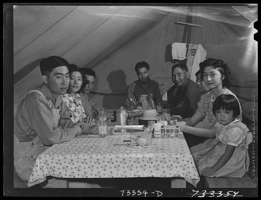 Nyssa, Oregon. FSA (Farm Security Administration) mobile camp. Japanese mother and father with their American-born children in tent-home. One of the sons of this family is in the United States Army. Two of the sons were studying engineering at an American university before the evacuation and are now