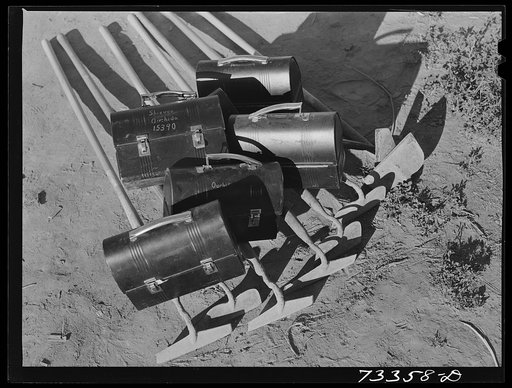 Nyssa, Oregon. Lunch boxes and hoes of one family of Japanese-Americans who live at the FSA (Farm Security Administration) mobile camp go to town one night a week for three hours in a supervised group