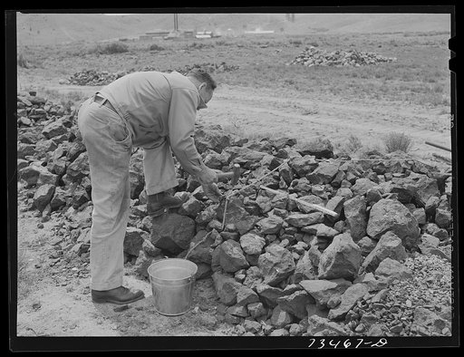 Seneca, Oregon. Agent of the metal reserves company samples specimens for assaying