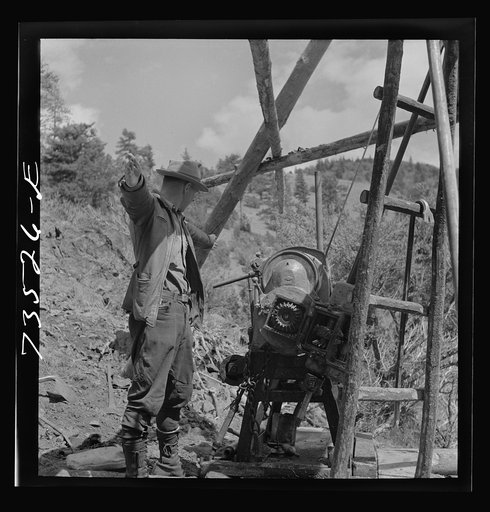 Grant County, Oregon. Bureau of Mines representative taking bearing on angle of diamond drilling for chrome ore deposits