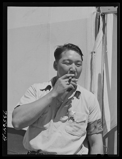 Nyssa, Oregon. FSA (Farm Security Administration) mobile camp. Japanese-American man who is one of the two special police at the camp now inhabited by the evacuated Japanese. The camp council, composed of members elected by the Japanese, appoints the special police