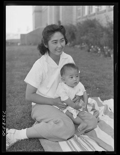 Nyssa, Oregon. Japanese-American mother and child at a baseball game. They were evacuated from a coastal area, volunteered to do farm work and now live at the FSA (Farm Security Administration) mobile camp
