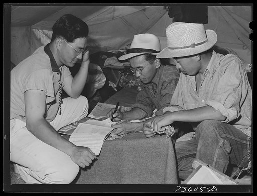 Nyssa, Oregon. FSA (Farm Security Administration) mobile camp. Japanese-Americans who do volunteer farm work and live at the camp signing the payroll. Volunteer work in connection with these people means paid work; they are guaranteed the standard local wage. They volunteered to leave the WCCA recep