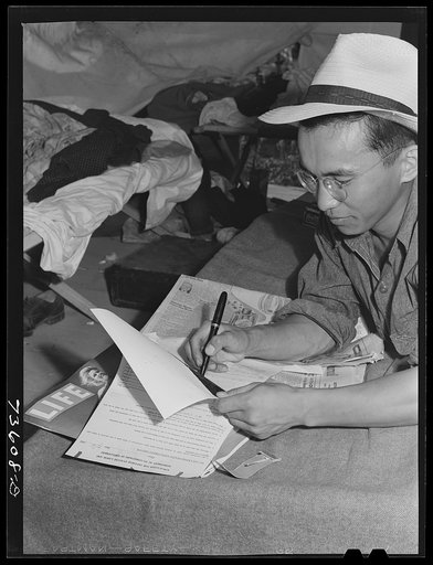 Nyssa, Oregon. FSA (Farm Security Administration) mobile camp. Japanese-Americans who do volunteer farm work and live at the camp signing the payroll. Volunteer work in connection with these people means paid work; they are guaranteed the standard local wage. They volunteered to leave the WCCA recep