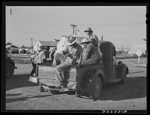 Nyssa, Oregon. FSA (Farm Security Administration) mobile camp. Japanese-American farm workers are transported from camp to fields by truck of the sugar beet company. Notice the representative of the U.S. Employment Service in white shirt who checks in the workers