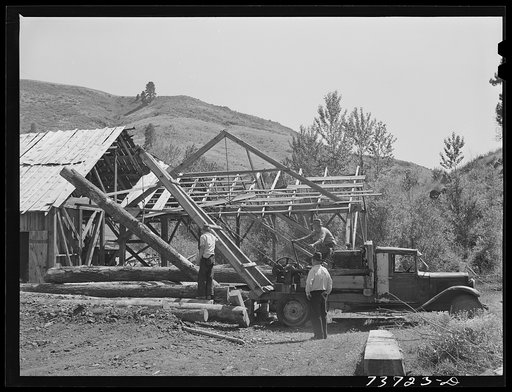 Ola, Idaho. FSA (Farm Security Administration) Ola self-help cooperative. A member places a hook on a log