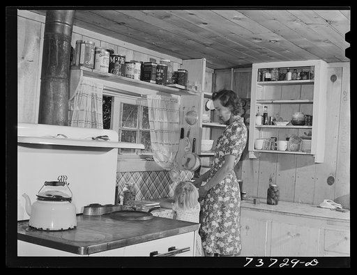 Ola, Idaho. FSA (Farm Security Administration) Ola self-help cooperative. Wife and child of a member in the kitchen of their home