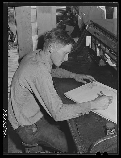 Ola, Idaho. FSA (Farm Security Administration) Ola self-help cooperative. The treasurer works on the books in the office