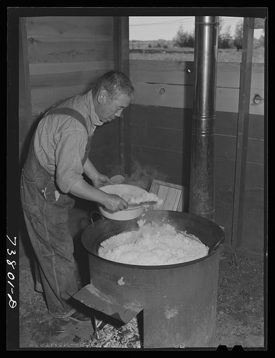 Shelley, Idaho. FSA (Farm Security Administration) mobile camp. Dishing up rice for supper in the cooperative mess of the Japanese living at the camp
