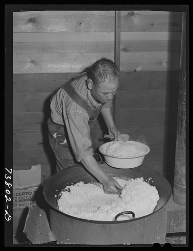 Shelley, Idaho. FSA (Farm Security Administration) mobile camp. Dishing up rice for supper in the cooperative mess of the Japanese living at the camp