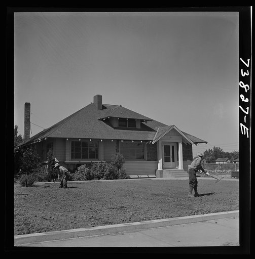 Shelley, Idaho. Japanese farm worker who lives at the FSA (Farm Security Administration) mobile camp working on a lawn in town