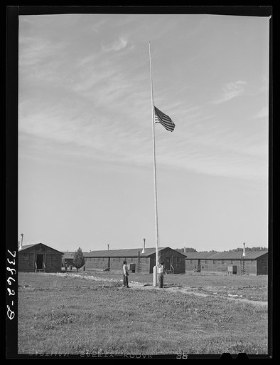 Rupert, Idaho. Former CCC (Civilian Conservation Corps) camp now under FSA (Farm Security Administration) management. Japanese-Americans taking down their flag in the evening