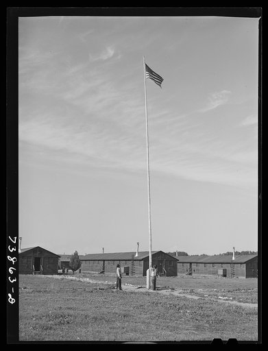 Rupert, Idaho. Former CCC (Civilian Conservation Corps) camp now under FSA (Farm Security Administration) management. Japanese-Americans taking down their flag in the evening
