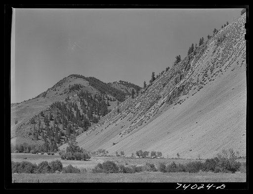 Untitled photo, possibly related to: Custer County, Idaho. Valley meadows are at the foot of steep mountains along the Salmon River