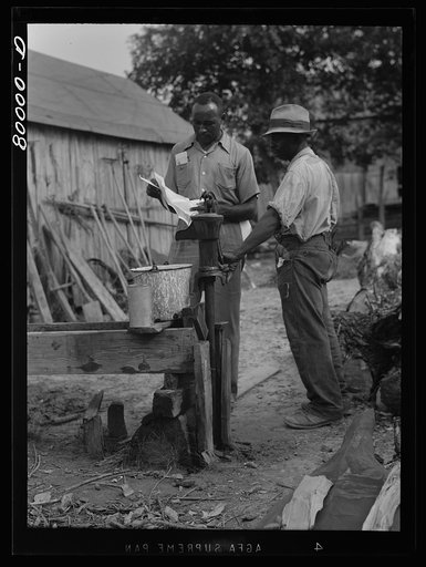 A FSA (Farm Security Administration) supervisor consults a borrower about unsanitary water supply. Safe well demonstration, near La Plata, Maryland. Charles County