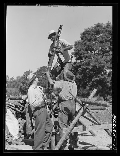 Pump is lifted and slipped down over pump rod. John Fredrick well project, Saint Mary's County, Maryland