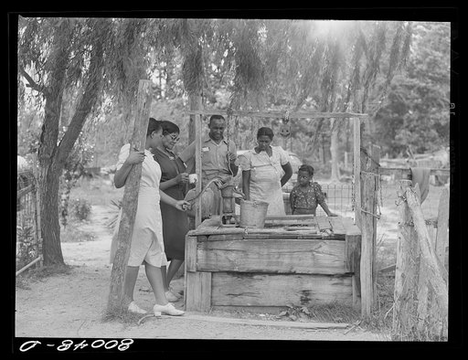 Negro supervisor explains the dangers of this shallow well to FSA (Farm Security Administration) borrower. Ridge, Maryland. Saint Mary's County