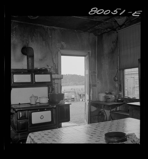 Interior of Biscoe kitchen. A fine stove, but no screens, and the plaster was falling off the walls. John Biscoe farmhouse, Ridge, Maryland. Saint Mary's County
