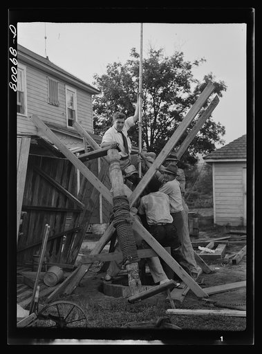 Untitled photo, possibly related to: Pump is lowered on pump rod and casing before settling drop pipe in place. Long well project, Saint Mary's County, Maryland