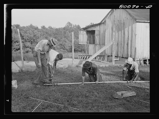 Cylinder is screwed onto drop pipe. Long well project, Saint Mary's County, Maryland
