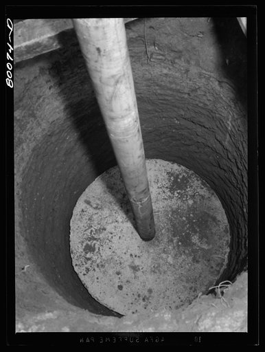 Metal casing threaded into cement cap ten feet down. Charles County, Maryland. Hardesty well project