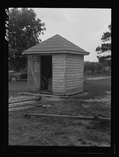 The water from this well is unsafe because surface water washes filth through wooden curbing despite the well house. Safe well demonstration near La Plata, Maryland. Charles County