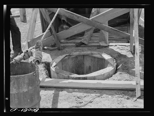 The old wood curbing permitted surface water to wash in between cracks. Safe well demonstration near La Plata, Maryland. Charles County