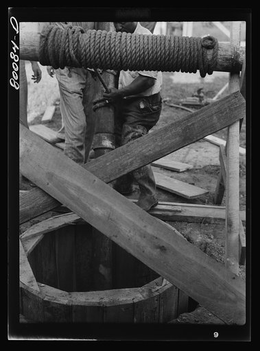 Lowering five foot steel casing into well. Safe well demonstration near La Plata, Maryland. Charles County