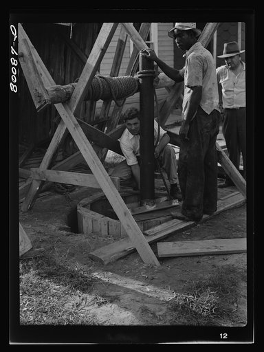 Placing the first piece of casing over the concrete culvert pipe. Safe well demonstration near La Plata, Maryland. Charles County