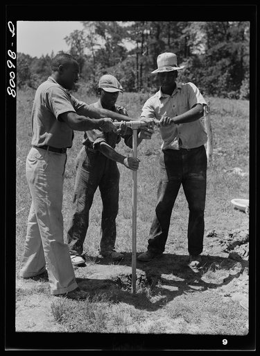 Manpower bores a shallow well if the soil is soft. Ridge well project, St. Mary's County, Maryland