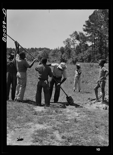 Removing a load of soil from auger as taken from well. Safe well demonstration, Ridge, Saint Mary's County, Maryland