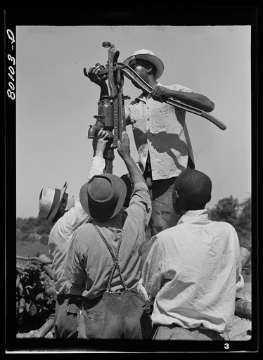 Attaching pump to drop pipe. Safe well demonstration near La Plata, Maryland. Charles County