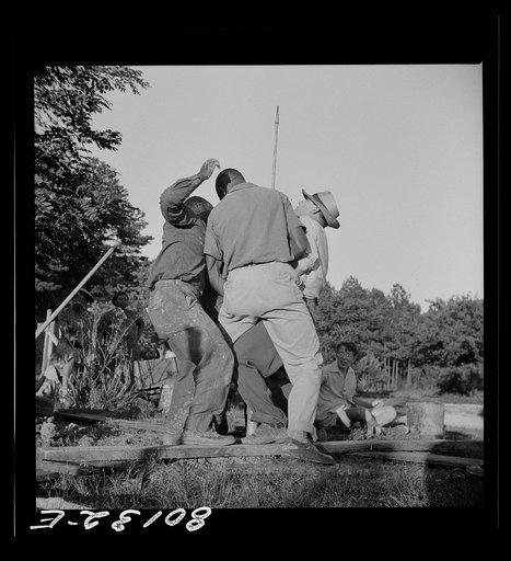 Mr. Slater, engineer, and well crew straining on pump rod, temporarily fouled in casing. Ridge well project, Saint Mary's County, Maryland