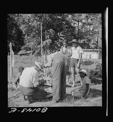 Everybody tries to learn. White FSA (Farm Security Administration)  engineer rigs pump. Ridge well project, Saint Mary's County, Maryland