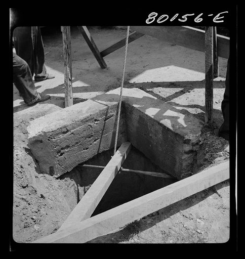 Lifting up old cement well top prior to cleaning and installing pump. Charles County, Maryland