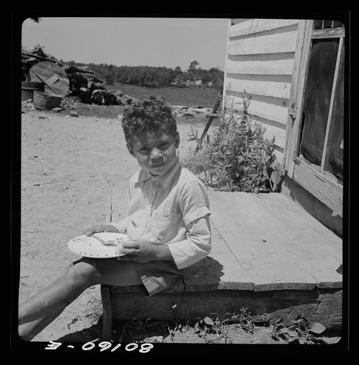 Untitled photo, possibly related to: John Fredrick's son eating his lunch in the sun. Charles County, Maryland, near La Plata, Maryland