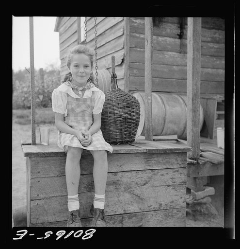 Untitled photo, possibly related to: Daughter of John Hardesty made a playhouse out of old well top. Charles County, Maryland