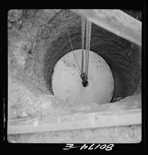 Untitled photo, possibly related to: Block and tackle hung from windlass serve as a rig to lower cement cap into place. John Hardesty well project, Charles County, Maryland