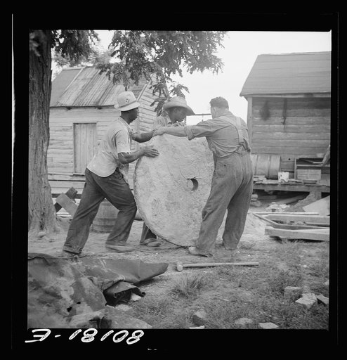The stone cap is rolled to the well. John Hardesty well project, Charles County, Maryland