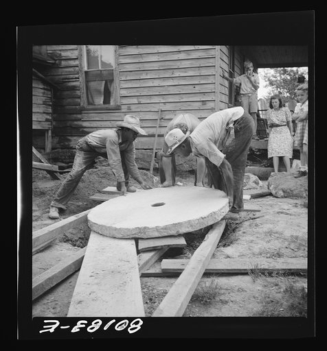 Sliding the present concrete slab to the well opening. Safe well demonstration near La Plata, Maryland. Charles County