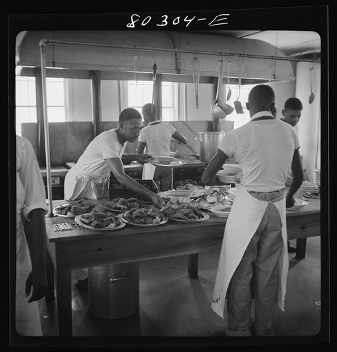 Craig Field cooks loading up platters of crisp fried chickens, supplied through the FSA (Farm Security Administration) "Food for Defense" program." Craig Field, Southeastern Air Training Center, Selma, Alabama