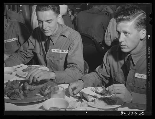 Cadet E.A. Peresich Jr. takes his third helping of fried chicken. Craig Field, Southeastern Air Training Center, Selma, Alabama (FSA (Farm Security Administration) "Food for Defense")