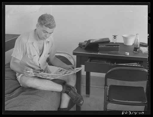 Craig Field flying cadet relaxes after a hearty meal of FSA (Farm Security Administration) fried chicken supplied through the "Food for Defense" program. Craig Field, Southeastern Air Training Center, Selma, Alabama