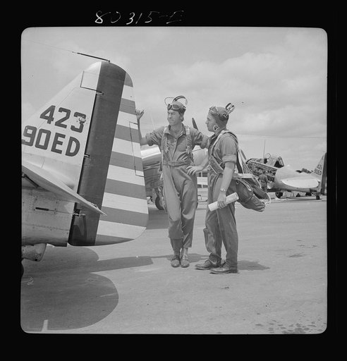 Flight instructors E.E. McTaggart and J.C. Gumison "talk things over" before the take-off. Craig Field, Southeastern Air Training Center, Selma, Alabama