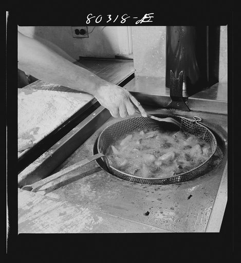 Sizzling in deep fat, FSA (Farm Security Administration) "Food for Defense" chickens for the Craig Field flying cadets' Sunday dinner. Craig Field, Southeastern Air Training Center, Selma, Alabama