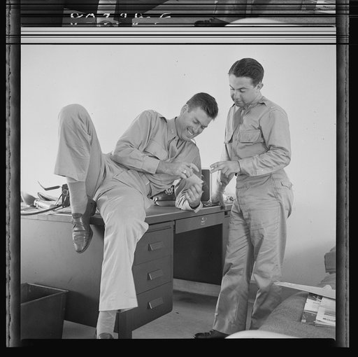 Flight instructors E.E. McTaggart and J.C. Peresich have a good laugh after a relaxing dinner of FSA (Farm Security Administration) "Food for Defense" chickens. Craig Field, Southeastern Air Training Center, Selma, Alabama