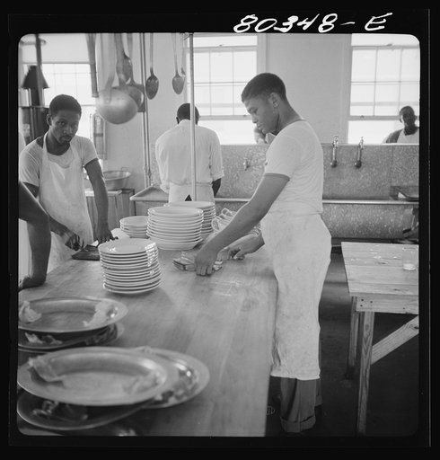 Craig Field cooks setting out plates for chicken dinner. Craig Field, Southeastern Air Training Center, Alabama