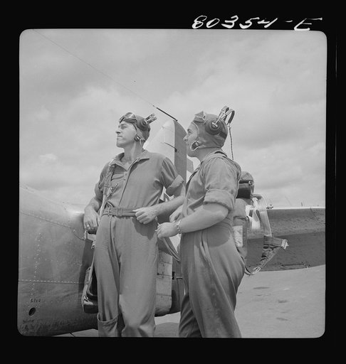 Untitled photo, possibly related to: Flight instructors McTaggart and Gumison chart the afternoon flight after dinner of fried chicken. Craig Field, Southeastern Air Training Center, Alabama