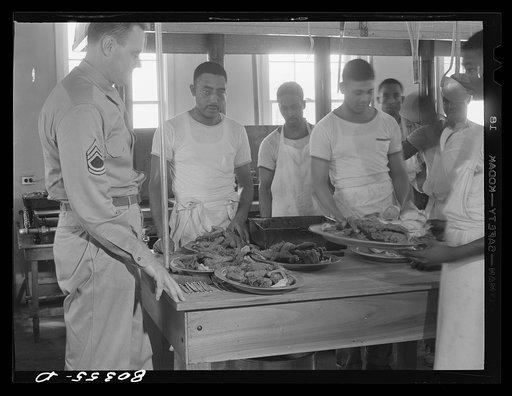 Untitled photo, possibly related to: Craig Field cooks loading up platters of crisp fried chickens, supplied through the FSA (Farm Security Administration) "Food for Defense" program." Craig Field, Southeastern Air Training Center, Selma, Alabama