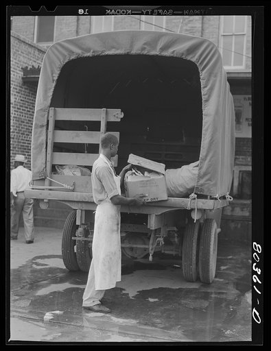 Untitled photo, possibly related to: Craig Field cook loads up with FSA (Farm Security Administration) "Food for Defense" chickens bound for the Flying Cadets Mess, Craig Field, Southeastern Air Training Center, Selma, Alabama